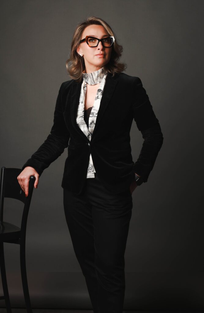 Approachable business portrait of a smiling businesswoman in a velvet blazer, Brussels